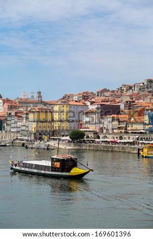 PORTO, PORTUGAL - SEPTEMBER 5: Tourist boat on Douro river in Porto, Portugal at September 5, 2013. Historic Centre of Porto is a UNESCO World Heritage Site since 1996.