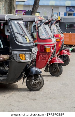 COLOMBO, SRI LANKA - JANUARY 18, 2014: Auto rickshaws or tuk-tuks on the street of Colombo. Most tuk-tuks in Sri Lanka are a slightly modified Indian Bajaj model, imported from India.