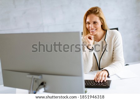 Similar – Image, Stock Photo Bbeautiful businesswoman working on laptop in bright modern office