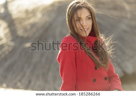 Pretty young woman in red coat