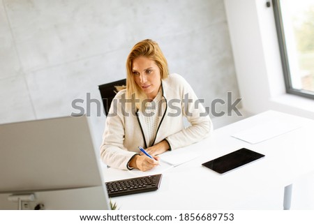Similar – Image, Stock Photo Bbeautiful businesswoman working on laptop in bright modern office