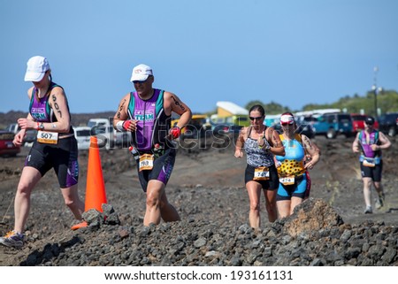 WAIKOLOA, USA - APRIL 3, 2011: Unidentified runner on the Lavaman Triathlon in Waikoloa, Hawaii. It is held in Olympics format: 1.5 km swimming, 40 km biking and 10 km running.