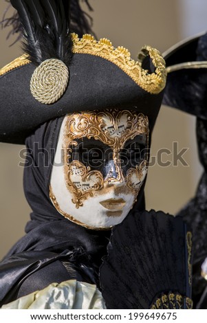 VENICE, ITALY - FEBRUARY 10, 2013: Unidentified person with traditional Venetian carnival mask in Venice, Italy. At 2013 it was held from January 26th to February 12th.