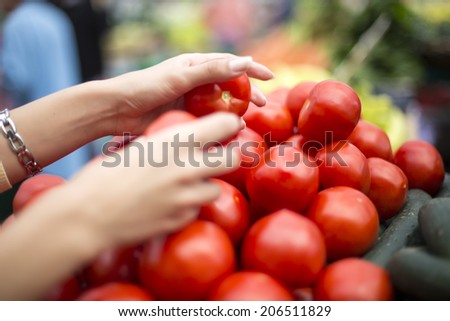 Woman buying fresh vegetables on the market