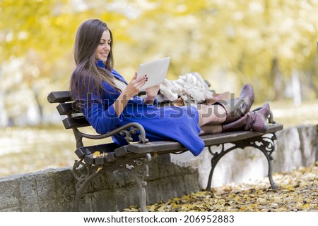 Young woman with tablet in the park
