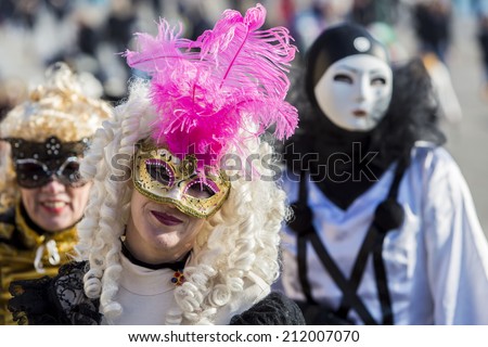 VENICE, ITALY - FEBRUARY 10, 2013: Unidentified people with Venetian carnival masks in Venice, Italy. At 2013 it is held from January 26th to February 12th.