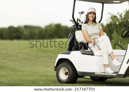 Young woman at golf cart
