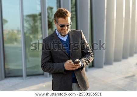 Similar – Foto Bild Gut gekleideter Mann beim Surfen auf dem Smartphone in der Stadt