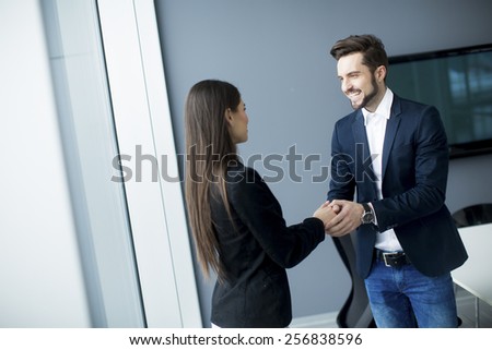Man and woman handshaking in the office