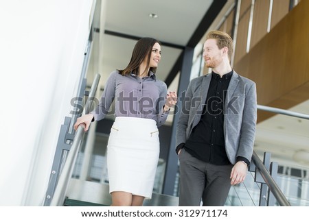 Young couple on the stairs in office