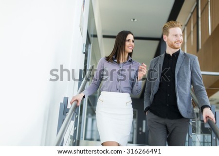 Young couple on the stairs in office