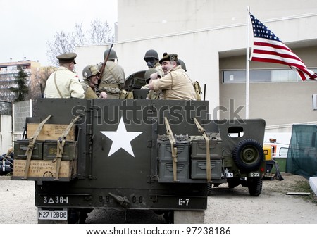 MADRID - MARCH 5: US Army soldiers and British soldiers on an US Army vehicle. Reconstruction of World War II by the 