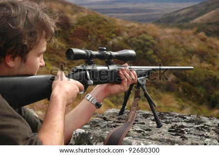 man aiming rifle
