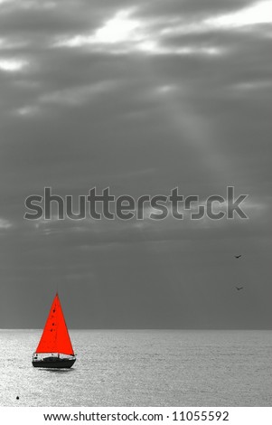 black and white picture of a sailing yacht with red sails