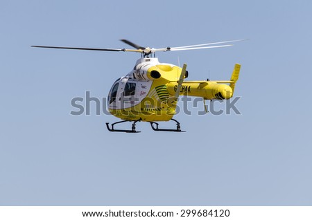 Clacton-on-sea, Essex, England, UK: 1 August 2013- Helicopter rescue, Yellow helicopter in the air while flying on blue sky, on its way to rescue someone.