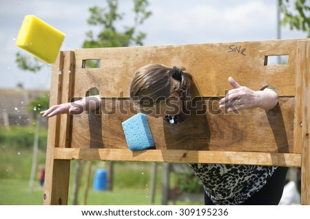 Little Clacton, Essex, England, UK: 27 May 2013- A school teacher being used in a wet sponge throwing contest, to raise money for the school she works at.