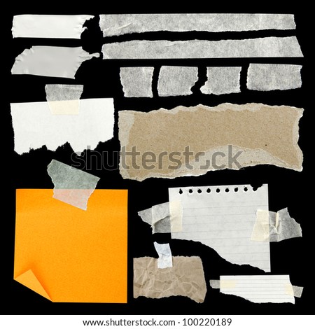 Pieces of torn paper and adhesive tape on black