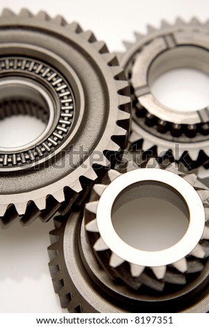 Closeup of three gears over white
