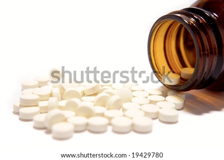 Pills spilling from bottle