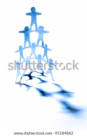 Paper doll people forming a human pyramid