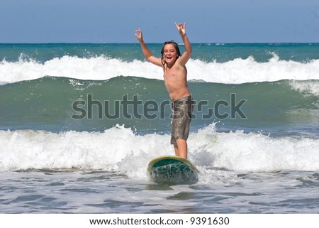A young caucasian male learns to surf on Whangaehu Beach, Central Hawkes Bay, New Zealand