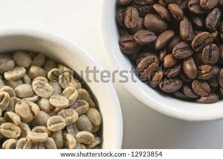 Green beans and roasted coffee beans on white background