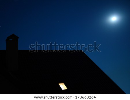 roof of the house with light in the window under moon