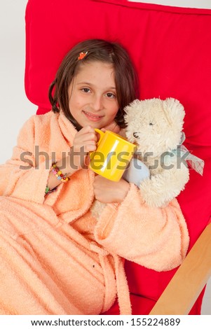 Little caucasian girl, brown hair, blue eyes, taking care of he sick teddy bear
