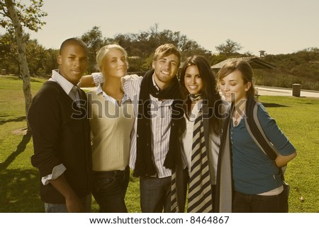 group of young interracial friends having fun in a park