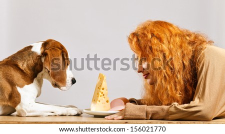 girl with cute beagle and  cheese on a white plate