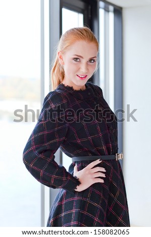 The young beautiful woman in knitted dress