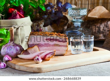 Vodka and smoked meat on a kichen table