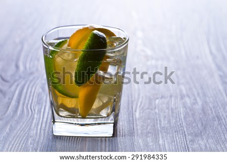 gin with tonic ,  lemon and ice on  old wooden table