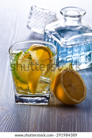 gin with tonic ,  lemon and ice on  old wooden table