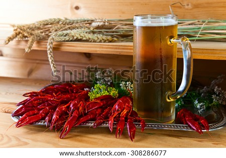 boiled crayfish with beer on wooden table