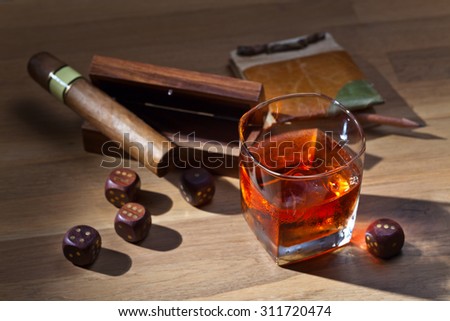whiskey and dice on a wooden table