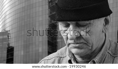 old man in black hat on a skyscraper  background