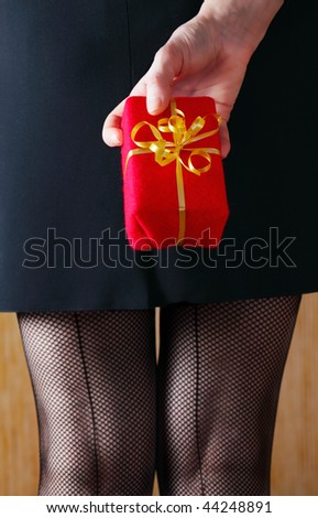 woman in black stockings with gift,focus on a box.