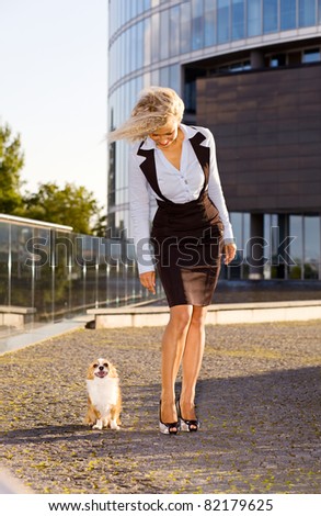 happy blond woman with chihuahua in downtown.