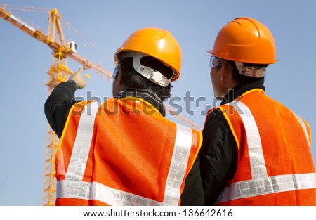 Two engineer construction. Site manager with safety vest discussion under construction