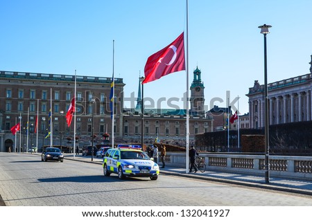 STOCKHOLM, SWEDEN - MARCH 11: The Royal Palace at the Turkish state visit at March 11, 2013 in Stockholm. The flags are flying half mast because of the Swedish Princess Lilian just had died.