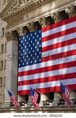 Lovely sun-dappled view of the historic New York Stock Exchange building draped in an American flag.