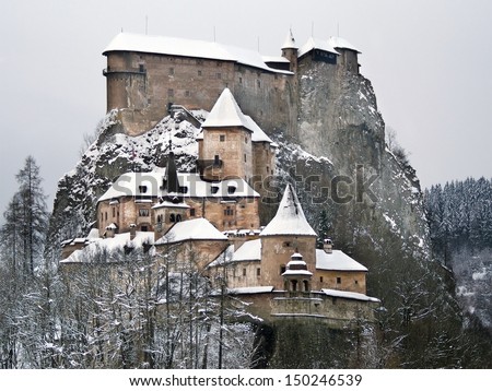 Rare view of famous Orava Castle in winter after strong snow storm. This castle is situated on a high rock above the river Orava, located in Oravsky Podzamok town, Orava region, northern Slovakia.