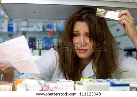 Beautiful woman pharmacist worried not finding medicine