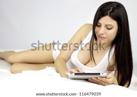 Gorgeous female model happy reading ipad tablet