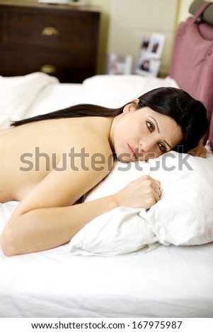 Sad woman in bed thinking