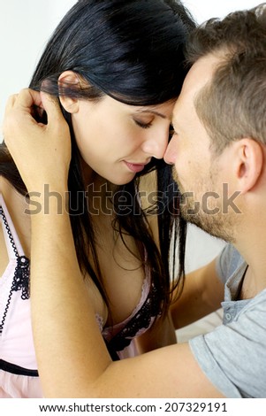 Man holding woman with closed eyes feeling love
