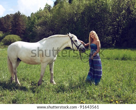 beautiful young woman with a horse in the forest