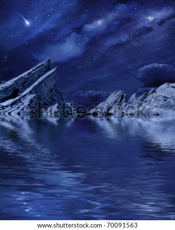 A desert landscape at night with moonlight and stars reflected in a calm lake.