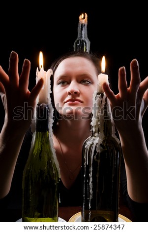 Women with candles on a black background.